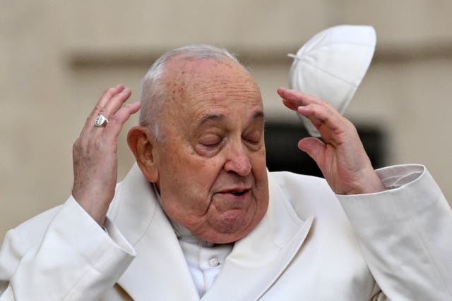 <p>Wind blows Pope Francis’ cap off his head as he arrives for his general audience in St. Peter Square at the Vatican on Monday </p>