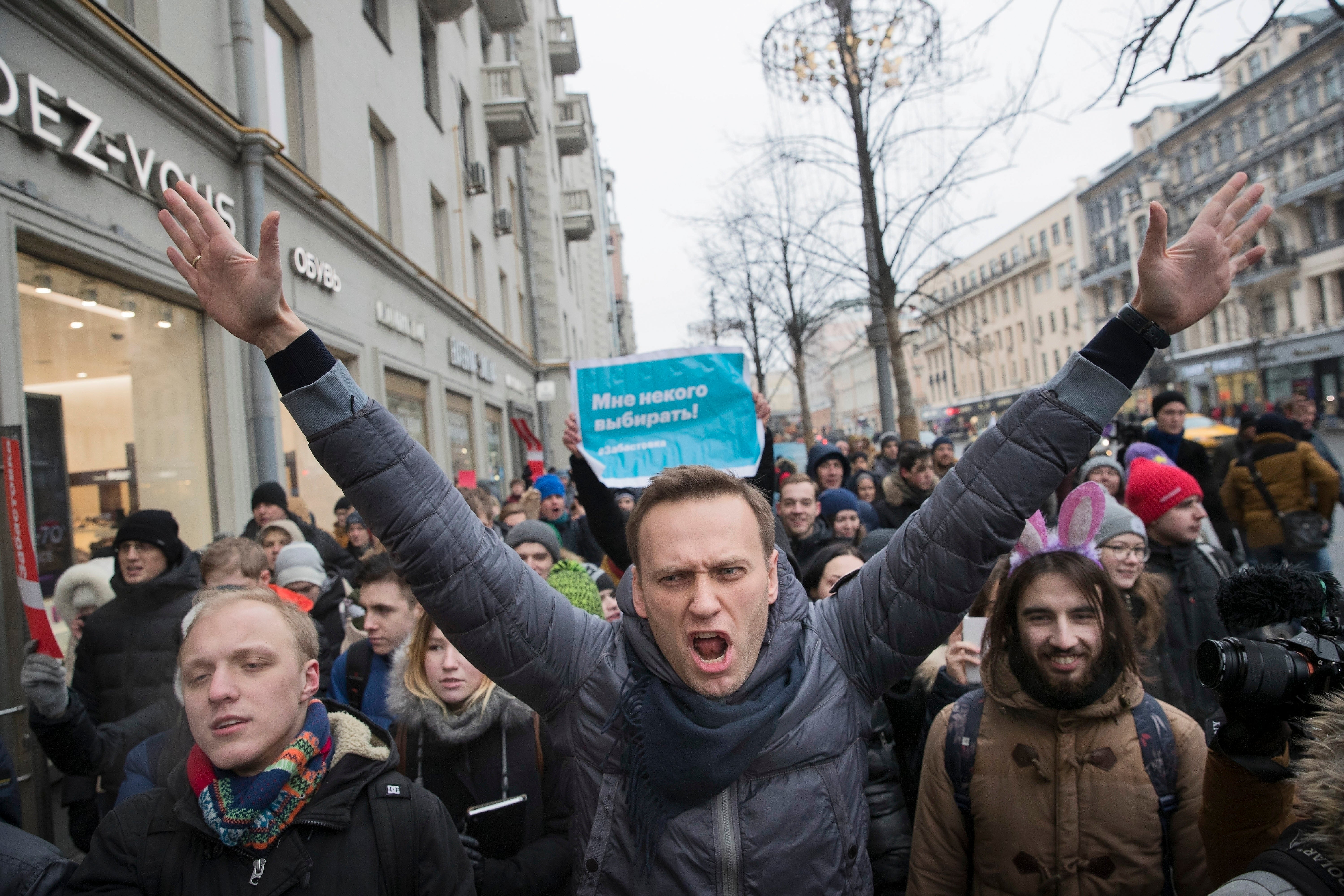 Russian opposition leader Alexei Navalny, center, left a plan to disturb the elections that will be enacted after his death