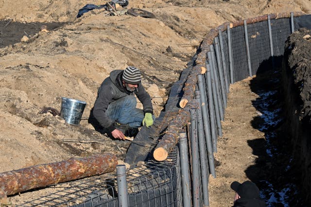 <p>A man works at the construction site of a defence line in Kharkiv region on March 12, 2024, amid the Russian invasion of Ukraine</p>