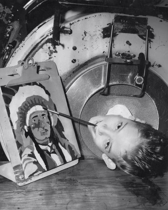 <p>Paul Alexander pictured as a young boy, as he learned to paint with his mouth </p>