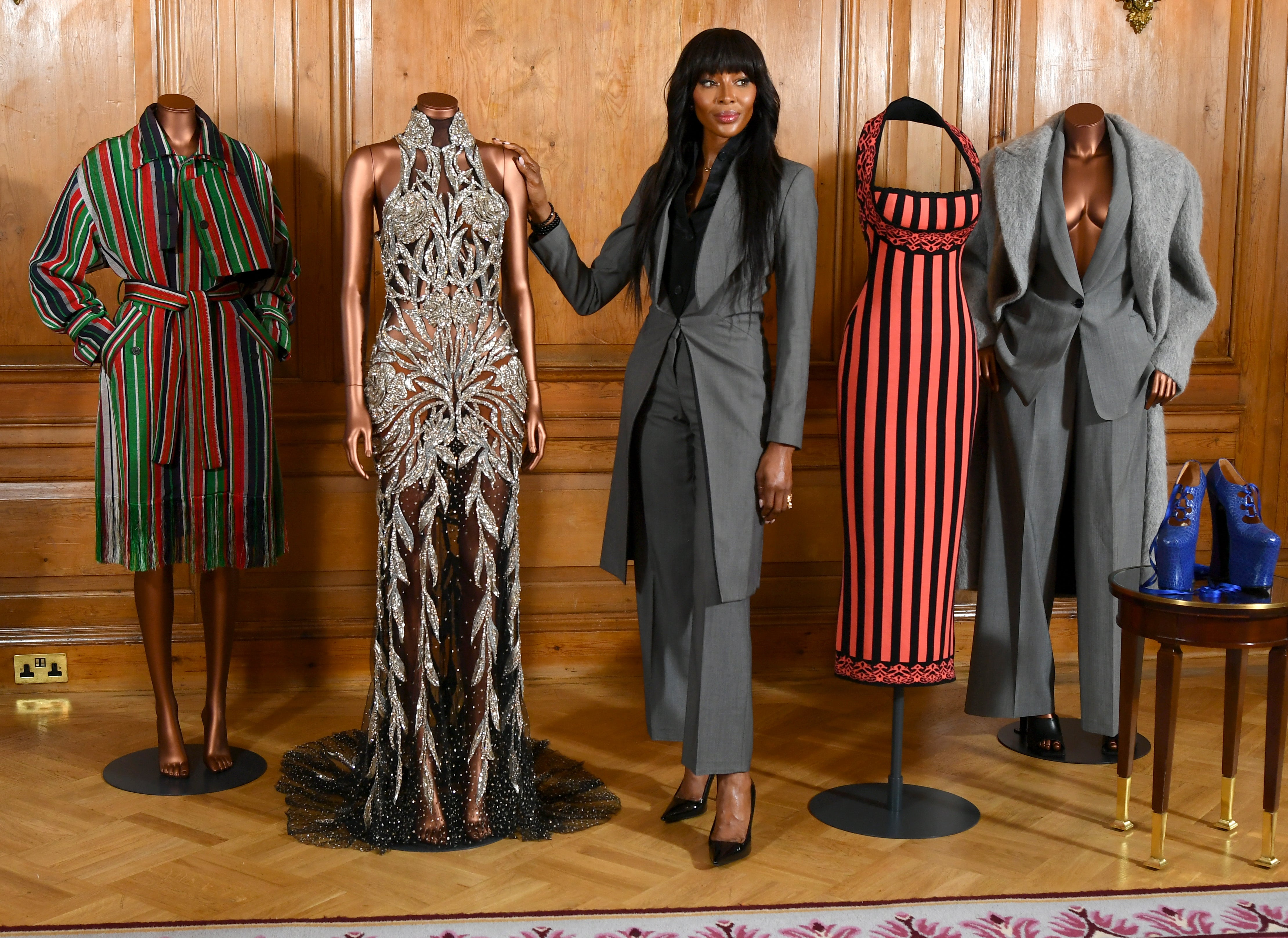 Campbell pictured alongside clothes that have typified key moments in her career