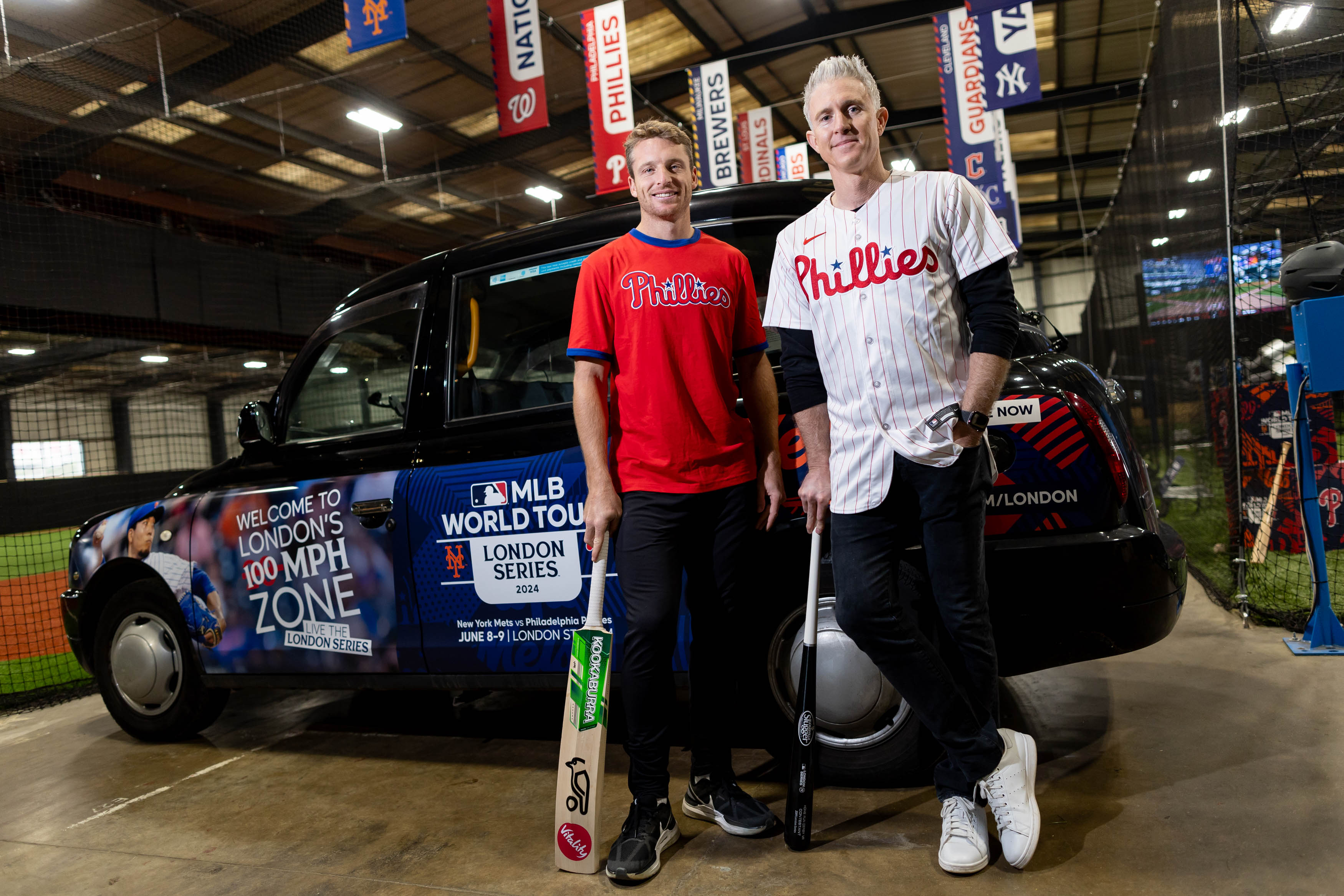 Jos Buttler and Chase Utley try out each other’s sports at an MLB and cricket event