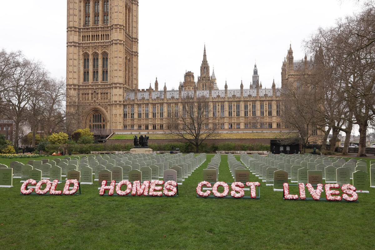 Greenpeace activists turned a park outside the Commons into a cemetery using headstones made from insulation boards