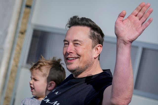 <p>Tesla’s CEO waves as he leaves one of the group’s giga-factories </p>