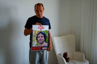 Nissan Kalderon poses with a photo of his only brother, Ofer, who is among those expected to be on the list of 33 hostages to be released in the first phase of the draft Israel-Hamas ceasefire deal