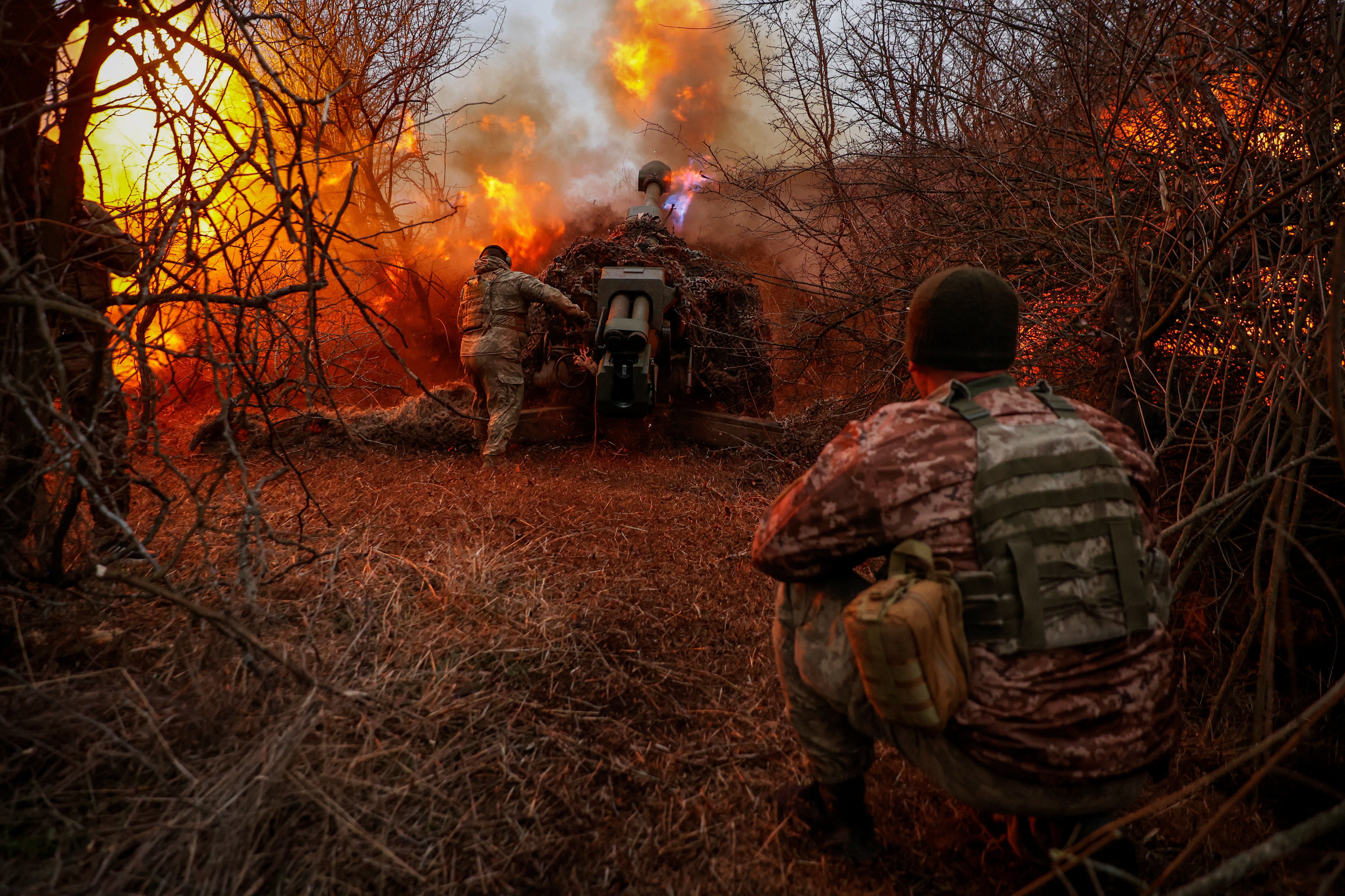 Ukrainian servicemen of the 126th Separate Territorial Defence Brigade fire a D-30 howitzer towards Russian troops at a position on a front line in Kherson region