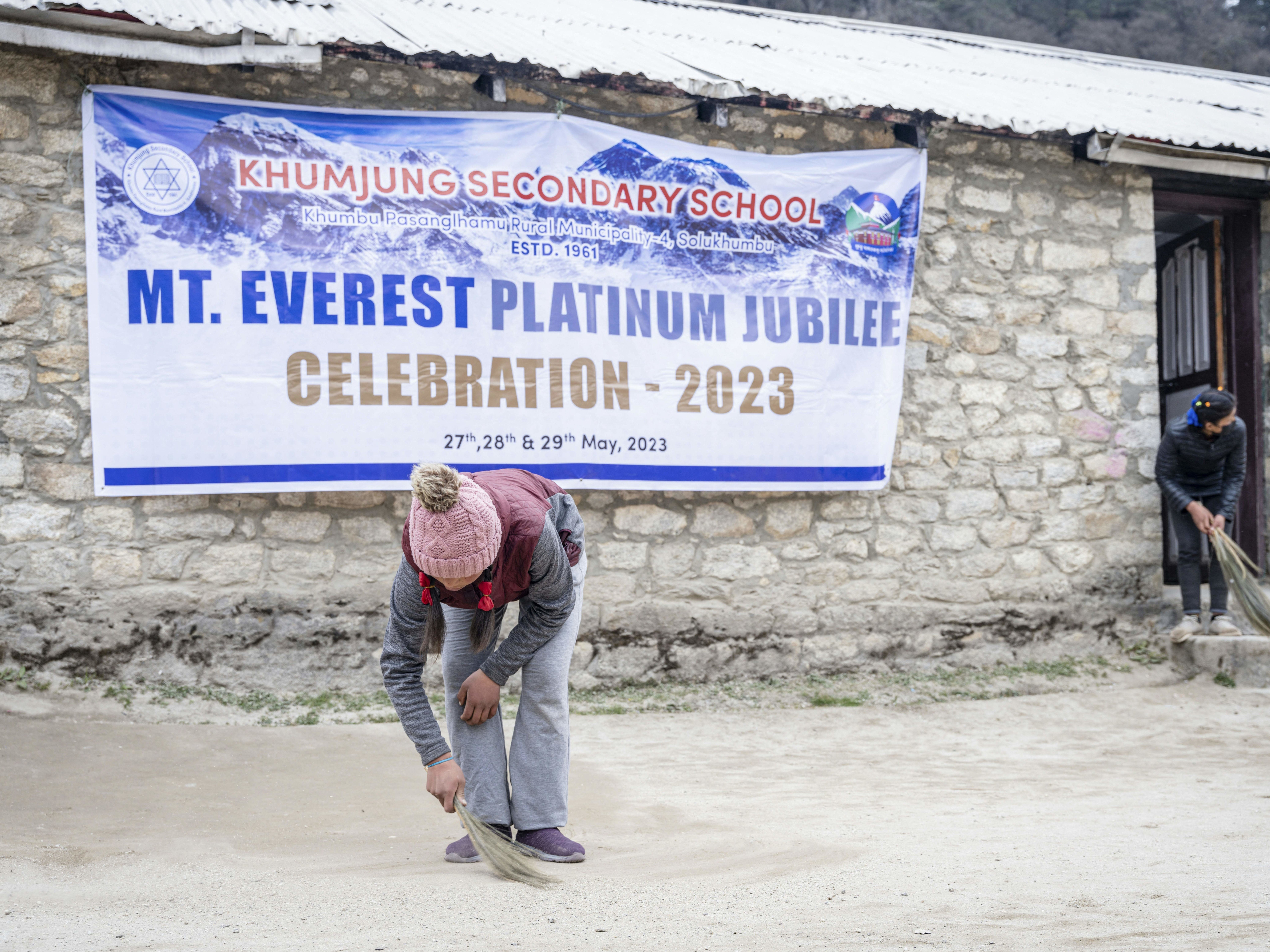 Students clean the Khumjung School which was established by Edmund Hillary, ahead of the Everest Day celebrations in the village of Khumjung, located in the shadow of Mount Everest