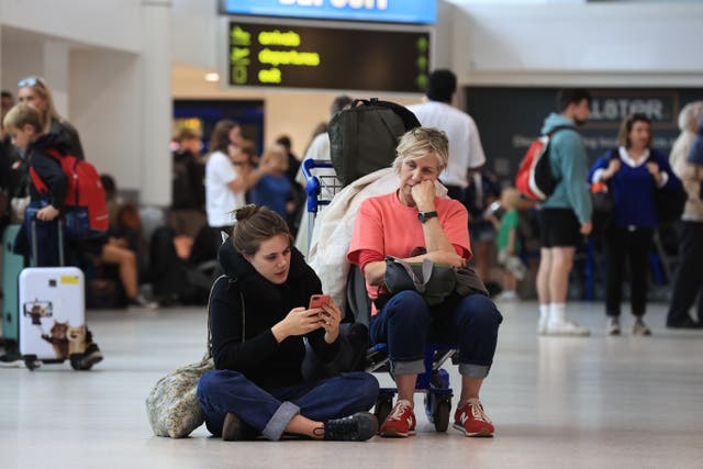 <p>Passengers at Belfast International Airport, as flights to the UK and Ireland were cancelled as a result of air traffic control issues in the UK</p>