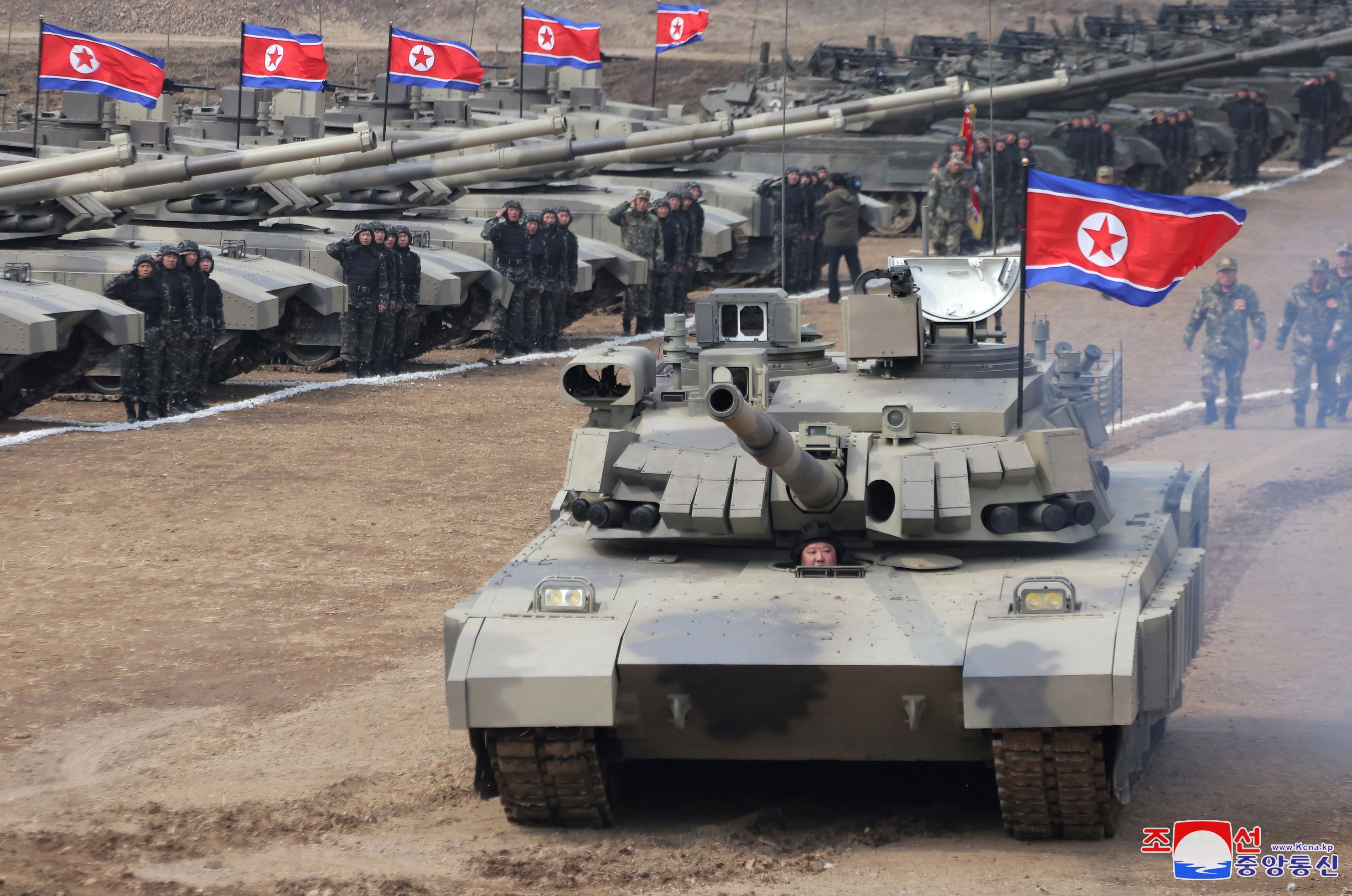 North Korean Supreme leader Kim Jong Un drives new-type tank during drills