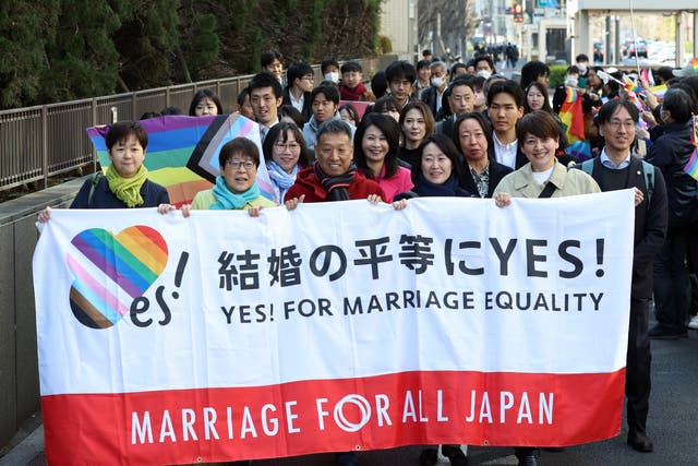 <p>Plaintiffs hold a banner before the ruling on same-sex marriage at the Tokyo District Court in Tokyo, Japan</p>