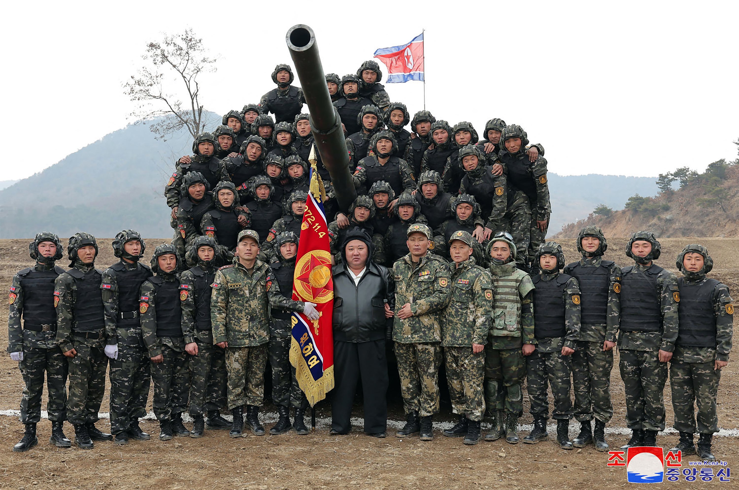North Korean leader Kim Jong Un (C) posing with personnel during a training competition between the combined forces of the Korean People’s Army tank crews at an undisclosed location in North Korea