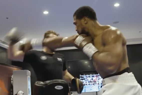 <p>Anthony Joshua (right) with coach Ben Davison backstage</p>