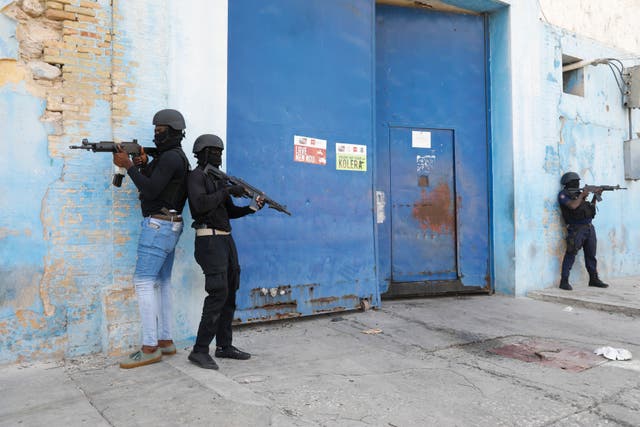 <p>National Police stand guard outside the empty National Penitentiary after a small fire inside in downtown Port-au-Prince, Haiti, Haiti, Thursday, March 14, 2024</p>