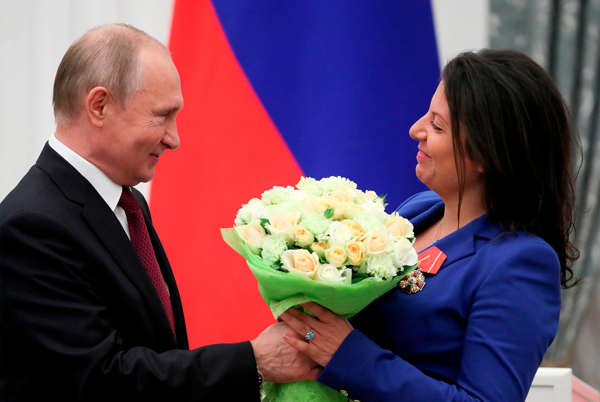 Putin presents flowers to the editor-in-chief of Russian state broadcaster RT, Margarita Simonyan, in 2019