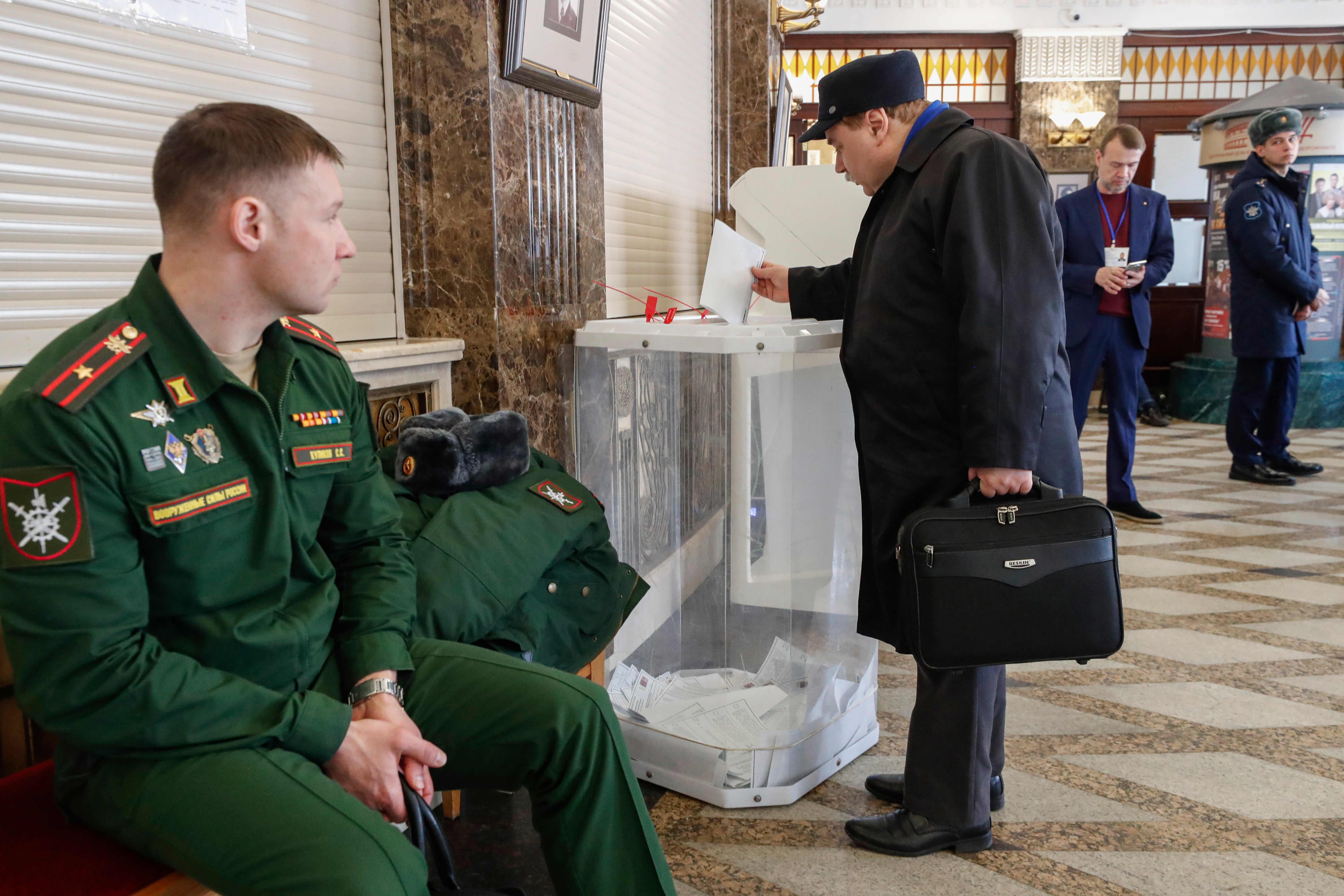 Muscovites cast their ballots during Russia’s presidential election