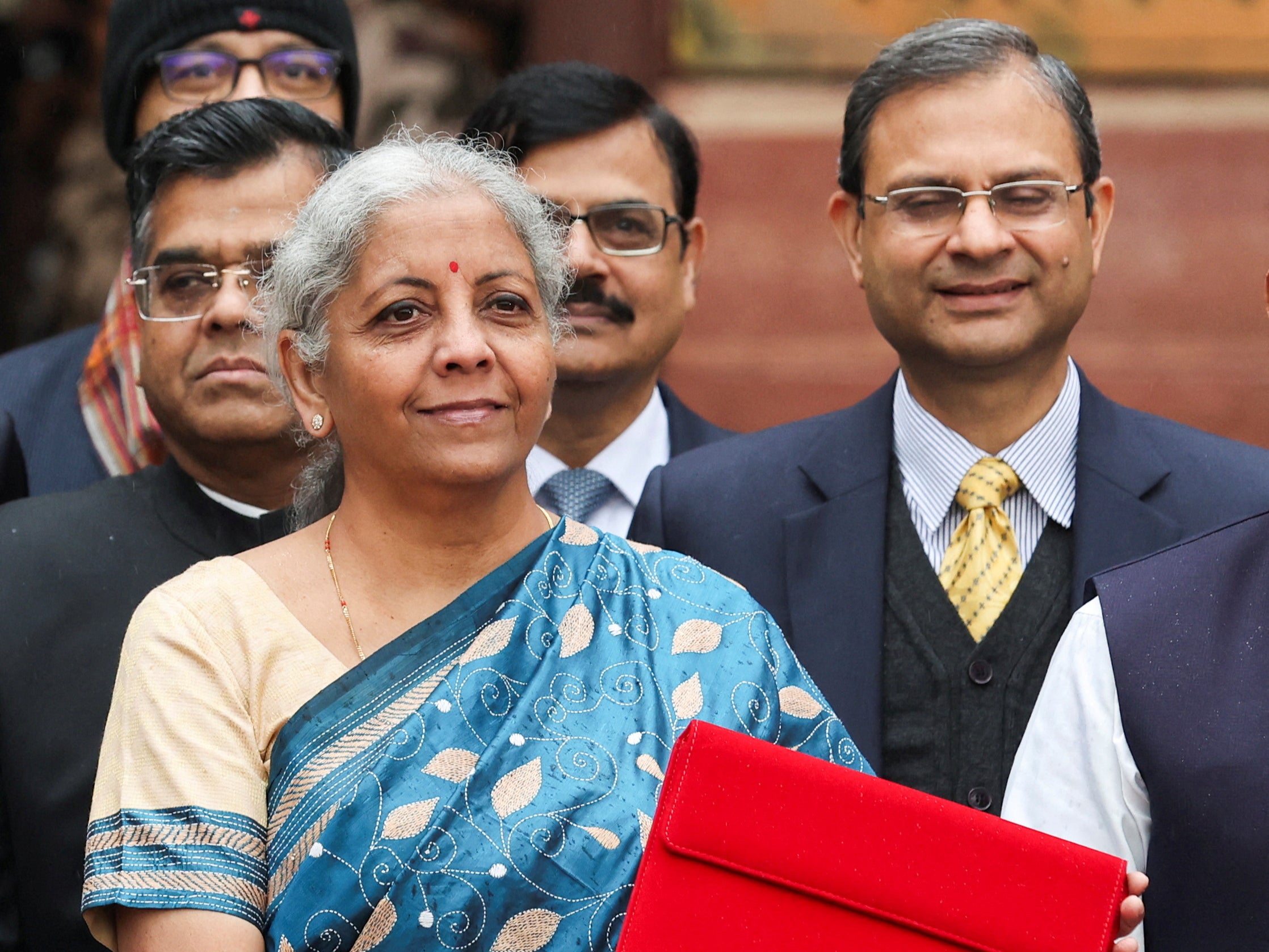 India’s finance minister Nirmala Sitharaman holds up a folder with the Government of India’s logo as she leaves her office to present the federal budget in the parliament