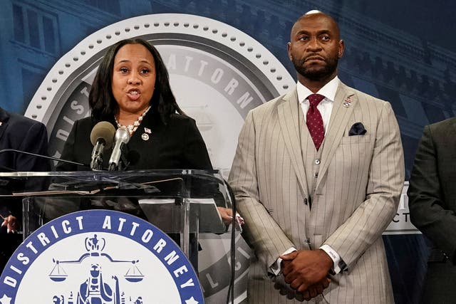 <p>Fulton County District Attorney Fani Willis and prosecutor Nathan Wade speak to reporters after a grand jury returned an indictment against Donald Trump in August 2023. </p>