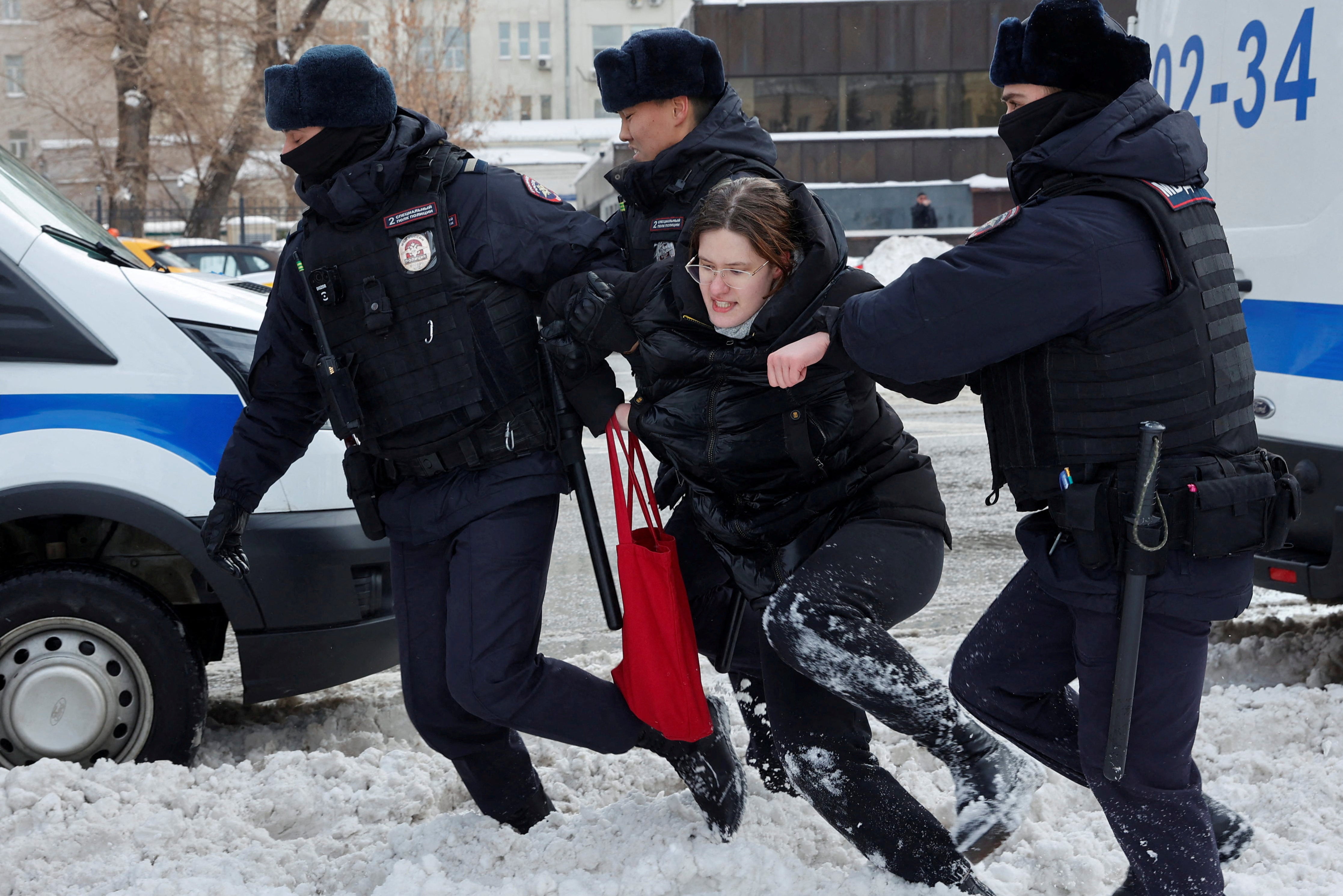 Police officers detain a woman during a gathering in memory of Russian opposition leader Alexei Navalny last month