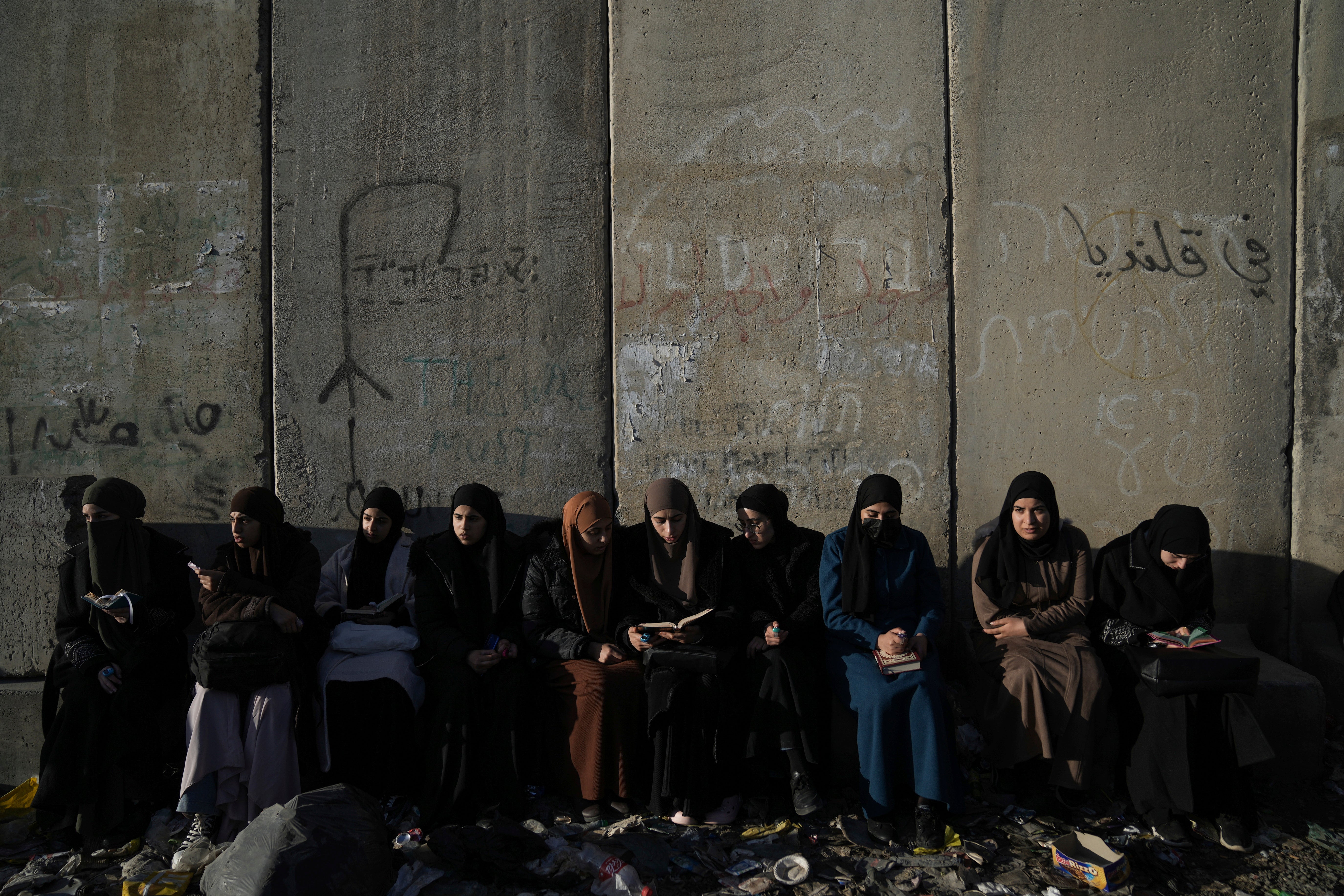 Palestinian women wait to cross the Israeli military Qalandia checkpoint near the West Bank city of Ramallah to Jerusalem