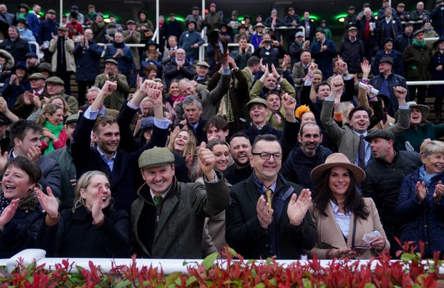 <p>Crowds enjoy watching a race during day three of the Cheltenham Festival, when attendance was down several thousand on last year</p>