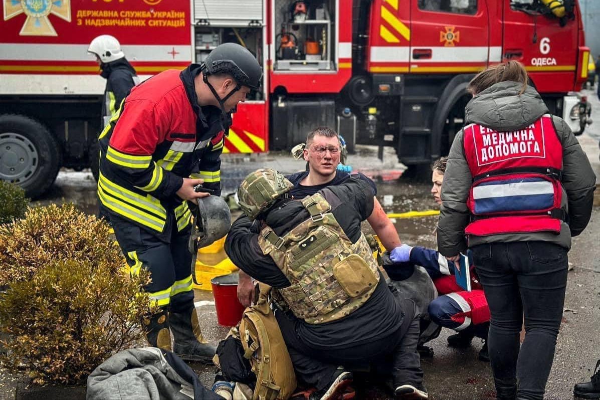 Emergency service workers tend to an injured man in the Ukrainian port city of Odesa on Friday