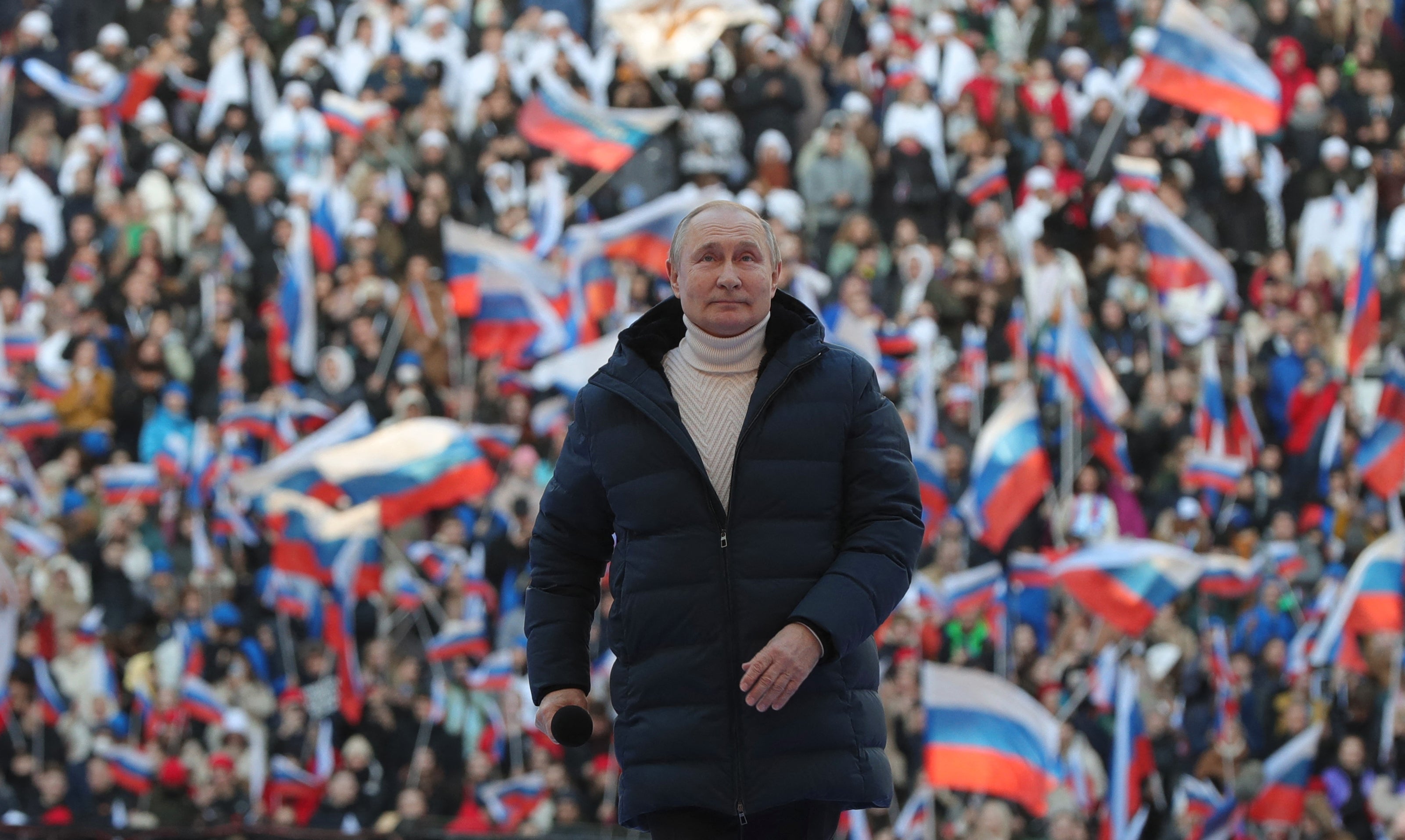 Vladimir Putin attends a concert marking the eighth anniversary of Russia's annexation of Crimea at the Luzhniki stadium in Moscow on March 18, 2022