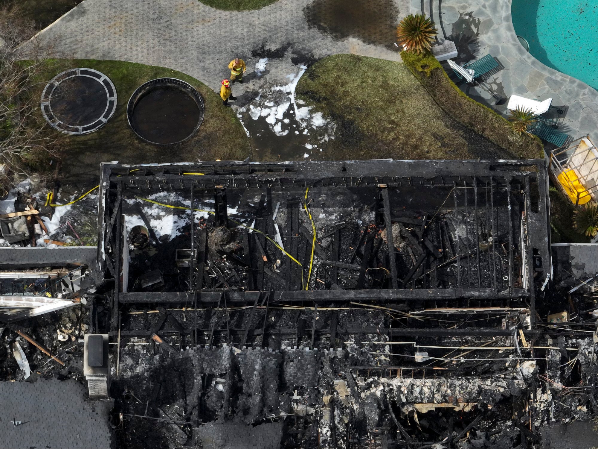 An aerial view shows the fire-damaged property