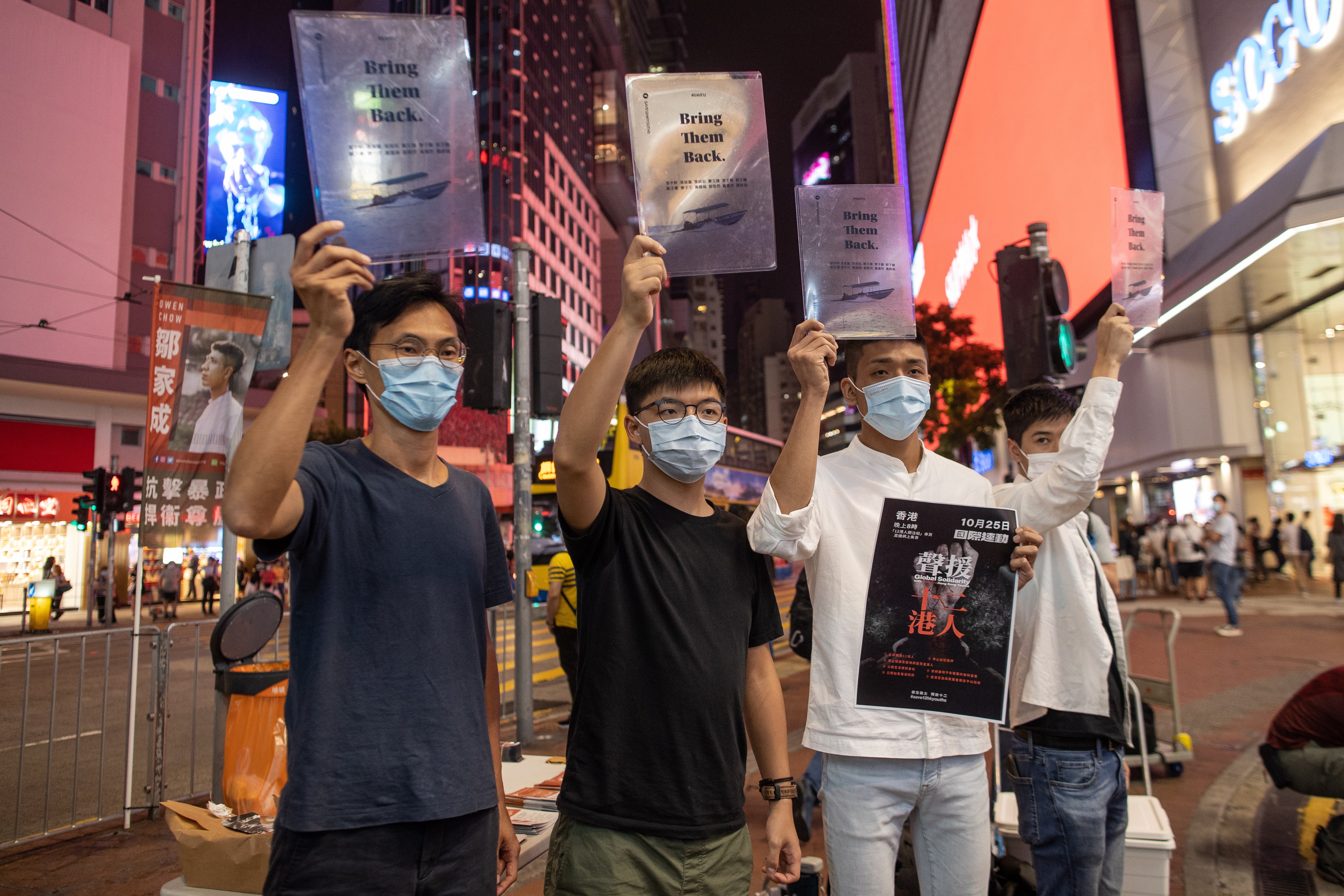 Pro-democracy activist Eddie Chu, (L), Joshua Wong Chi-fung, (2R), Owen Chow, (2R), and Lester Shum, (R), distribute leaflets in Hong Kong
