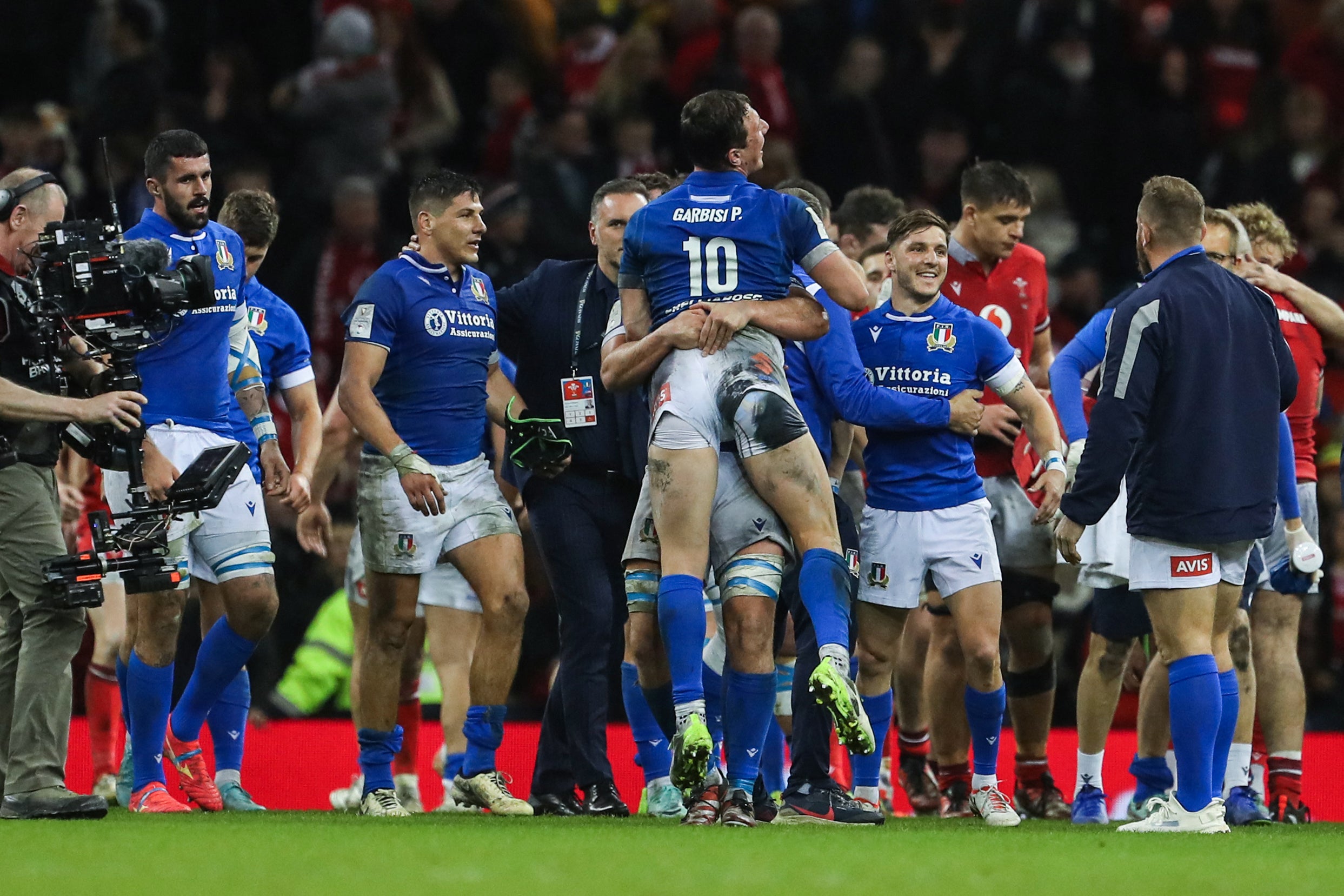 Italy celebrate a 24-21 victory over Wales in Cardiff