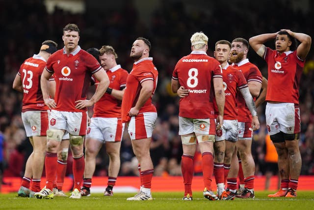 <p>Wales players appear dejected after losing to Italy</p>