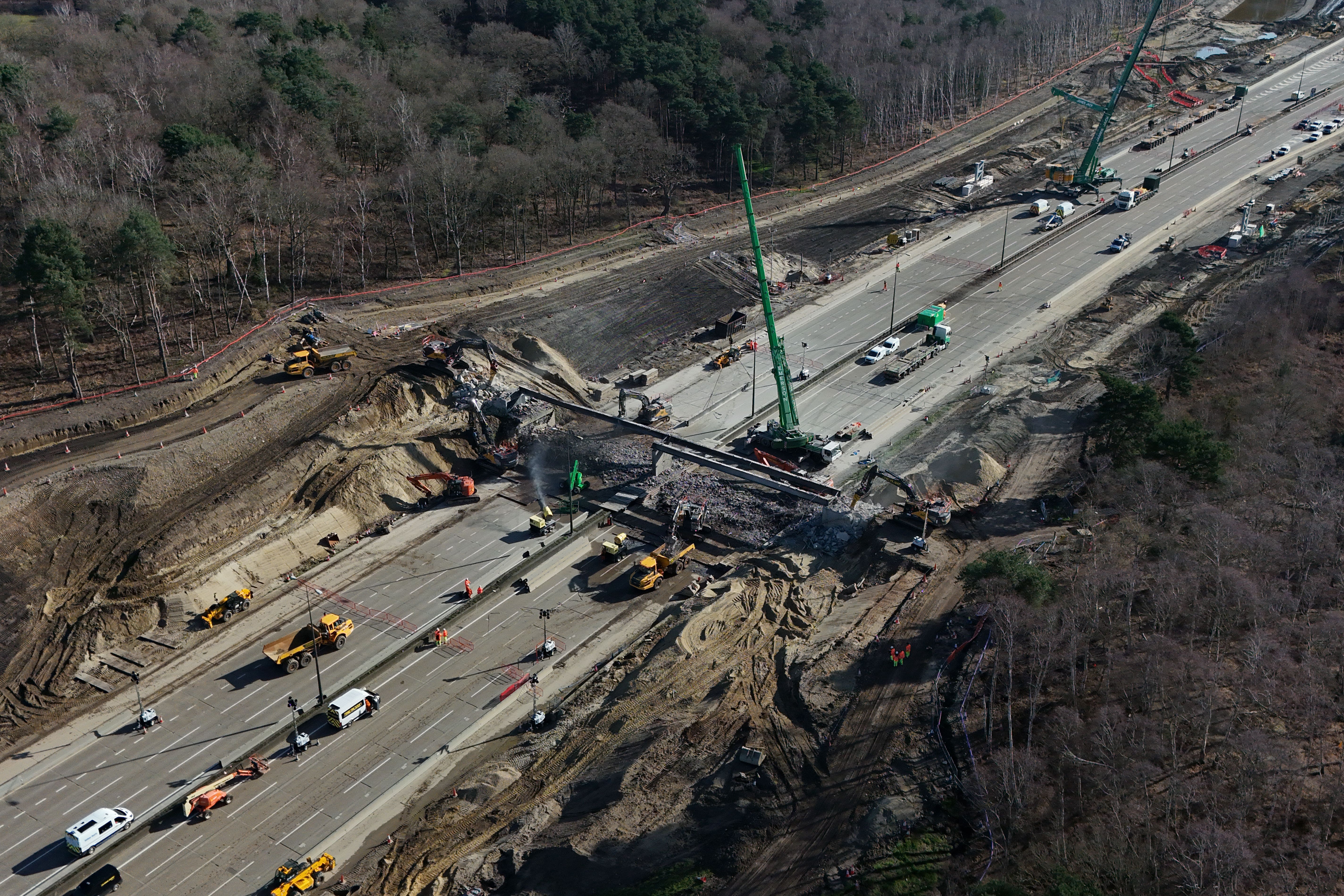 <p>A bridge is being demolished and a new gantry installed (Yui Mok/PA)</p>