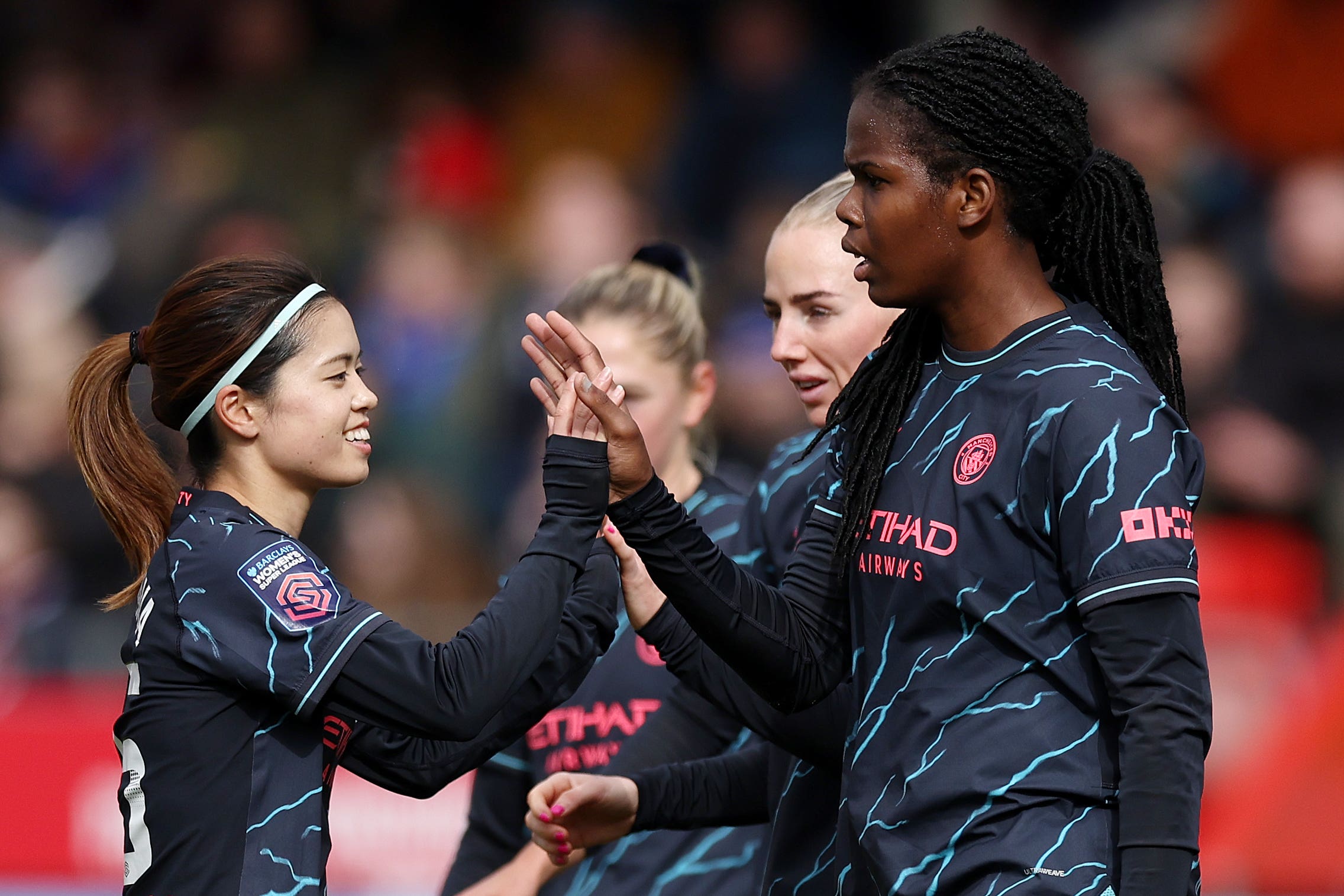 Khadija Shaw (right) celebrates scoring Manchester City’s third goal against Brighton