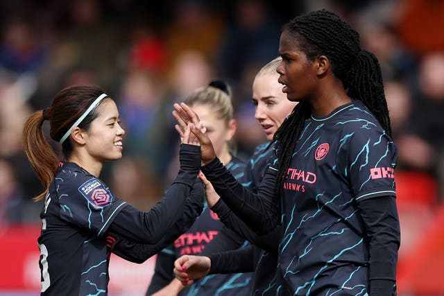 <p>Khadija Shaw (right) celebrates scoring Manchester City’s third goal against Brighton</p>