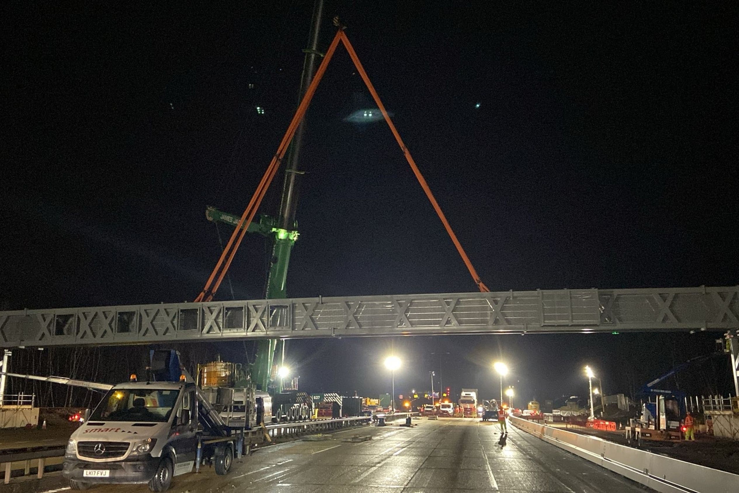 <p>A gantry being installed overnight on a closed section of the M25 motorway in Surrey (National Highways South-East/PA)</p>