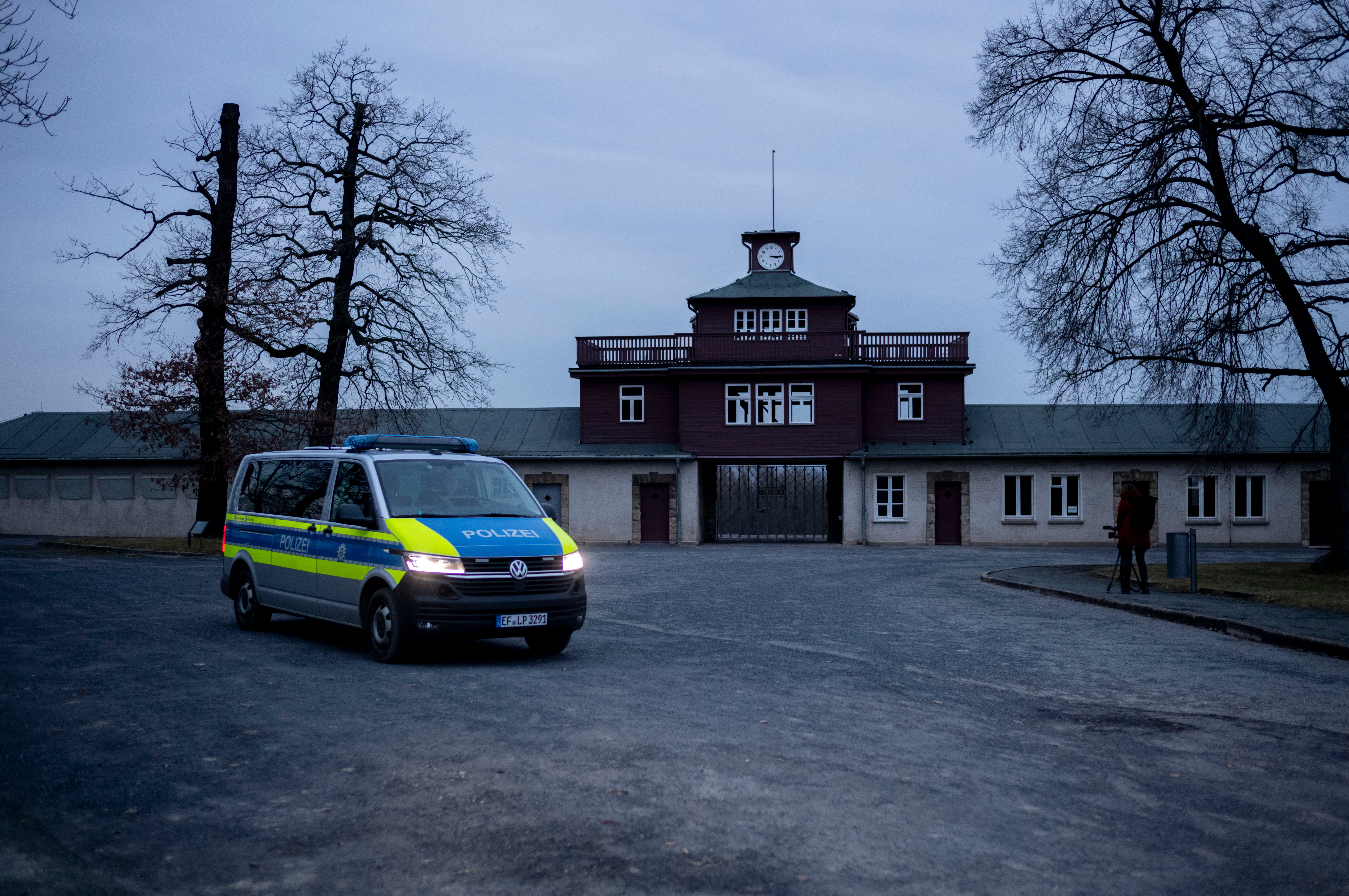 A police patrol officers in a car passes the main gate of the former Nazi concentration camp Buchenwald during a patrol in Weimar, Germany, Tuesday, January 30, 2024