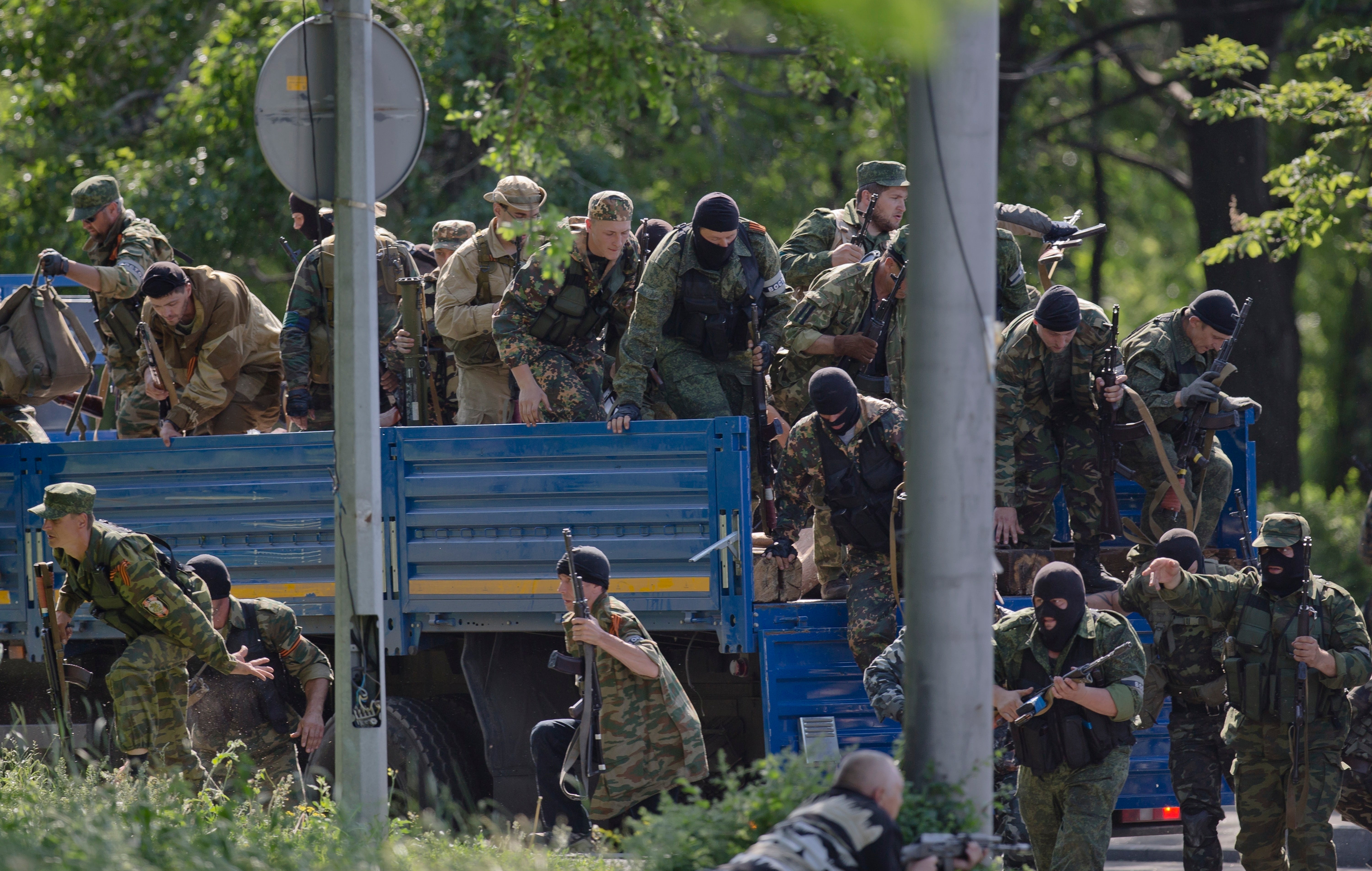 Pro-Russian gunmen take positions near the airport outside Donetsk, Ukraine, on Monday, May 26, 2014