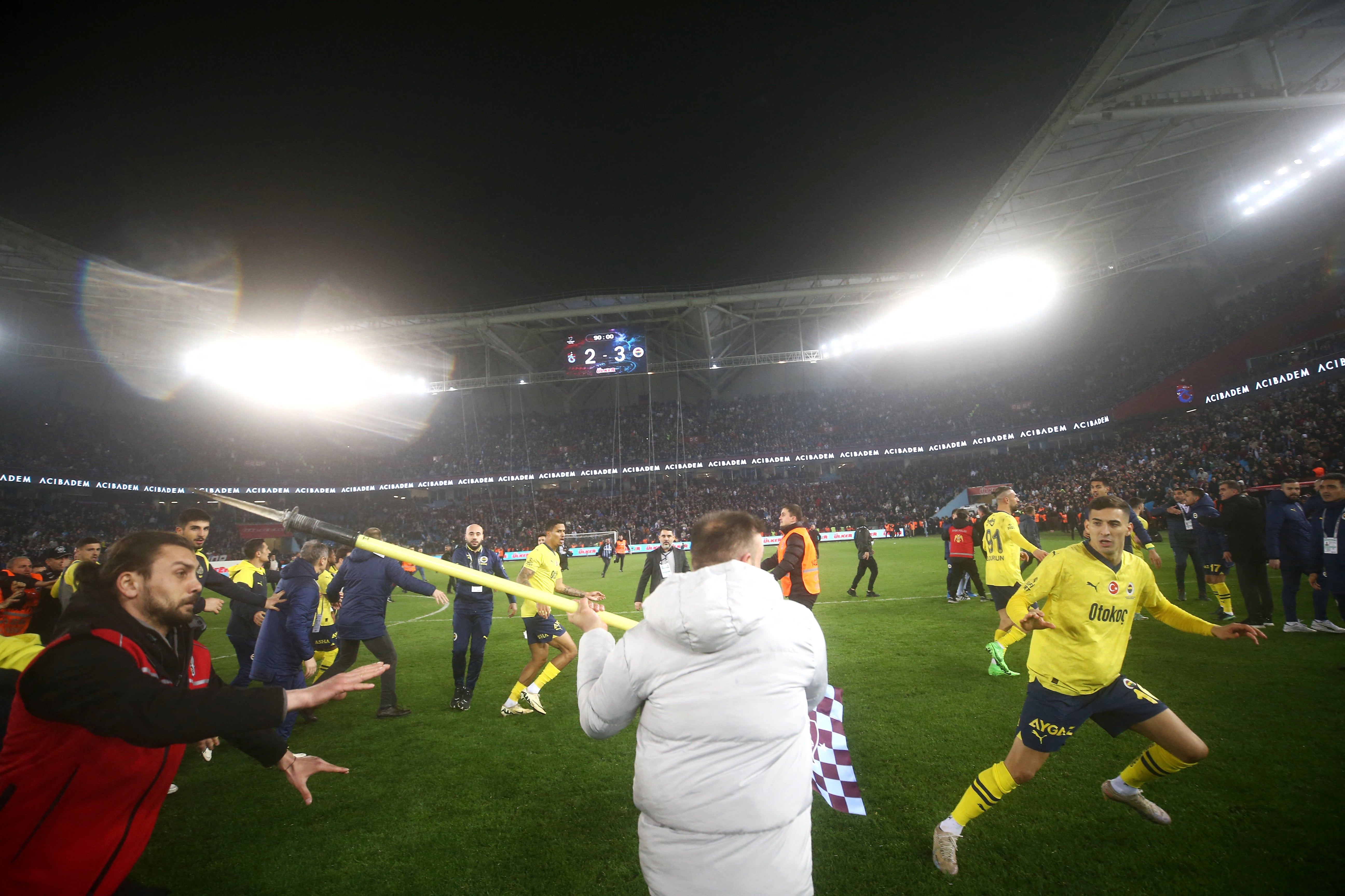Fenerbahce’s players are attacked by Trabzonspor supporters after the Turkey Super Lig match