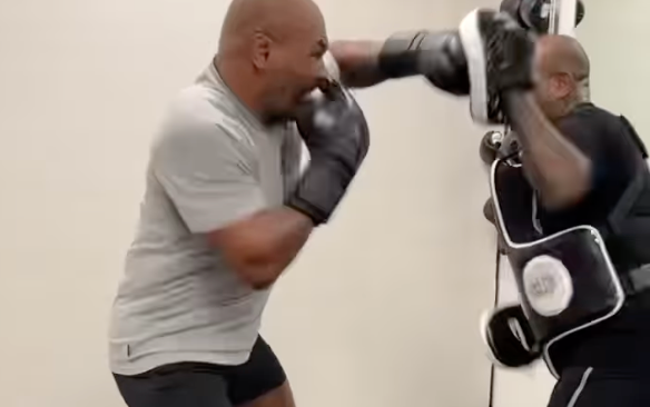 Mike Tyson pummels the pads in training for his fight with Jake Paul