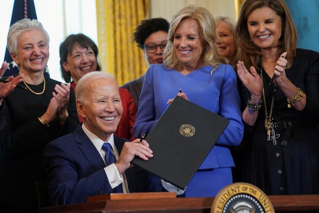 <p>Jill Biden and Maria Shriver clap as Joe Biden holds up an executive order to allocate billions for women’s health research</p>