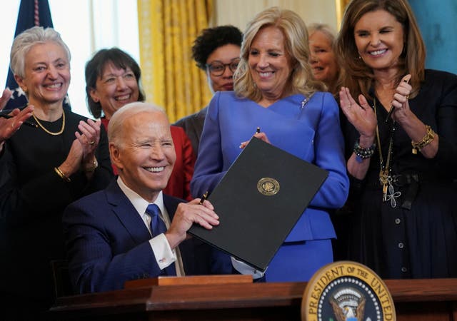<p>Jill Biden and Maria Shriver clap as Joe Biden holds up an executive order to allocate billions for women’s health research</p>