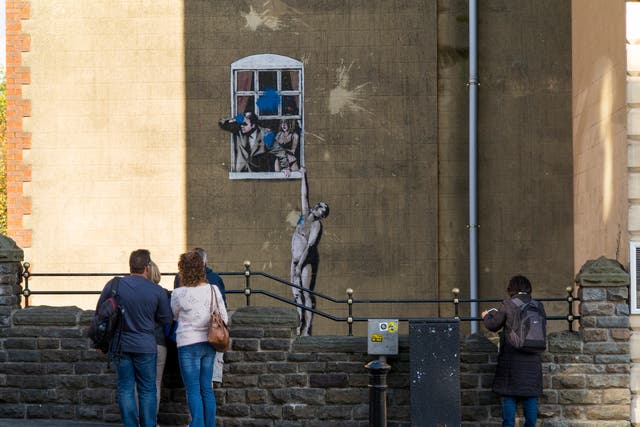 <p>Banksy’s ‘Well Hung Lover’ in Bristol</p>