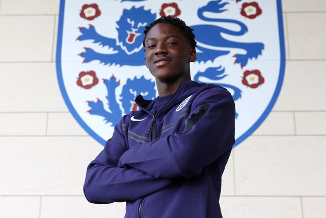 <p>Kobbie Mainoo poses for photos at St George’s Park after his late call up</p>