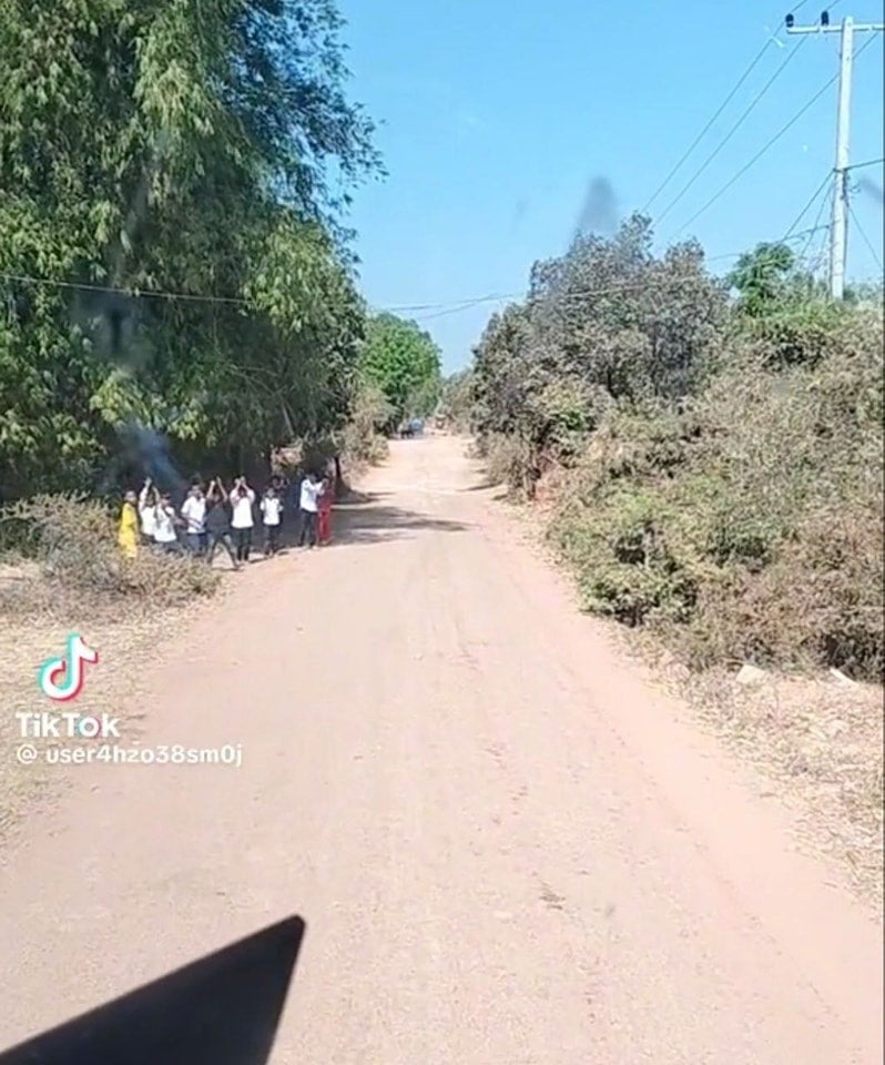 An image of children dancing on the side of the road as shared by the Cambodian PM