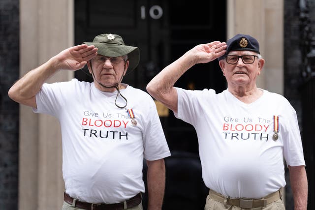 Veterans of Britain’s Cold War radiation experiments Terry Quinlan (left) and Brian Unthank (right) hand a petition in at Downing Street (Stefan Rousseau/PA)