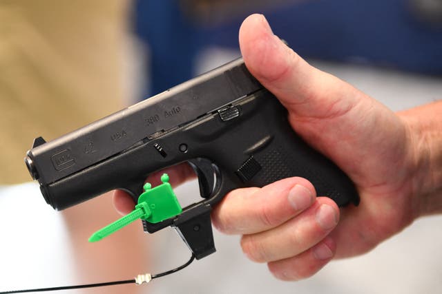 <p>An attendee holds a Glock Ges.m.b.H. GLOCK 42 .380 pistol during the National Rifle Association (NRA) Annual Meeting at the George R. Brown Convention Center, in Houston, Texas on 28 May 2022</p>