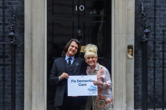 Dame Barbara Windsor and her husband Scott Mitchell deliver an Alzheimer’s Society open letter to 10 Downing Street in Westminster before she died (PA)