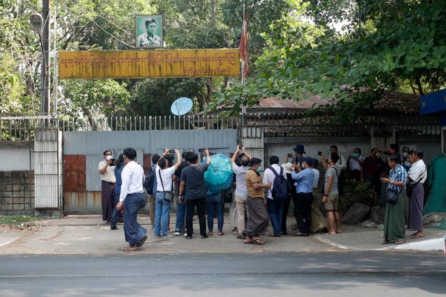 <p>Journalists and plainclothes officers gather in front of the home of ousted leader Aung San Suu Kyi in Yangon on Wednesday </p>