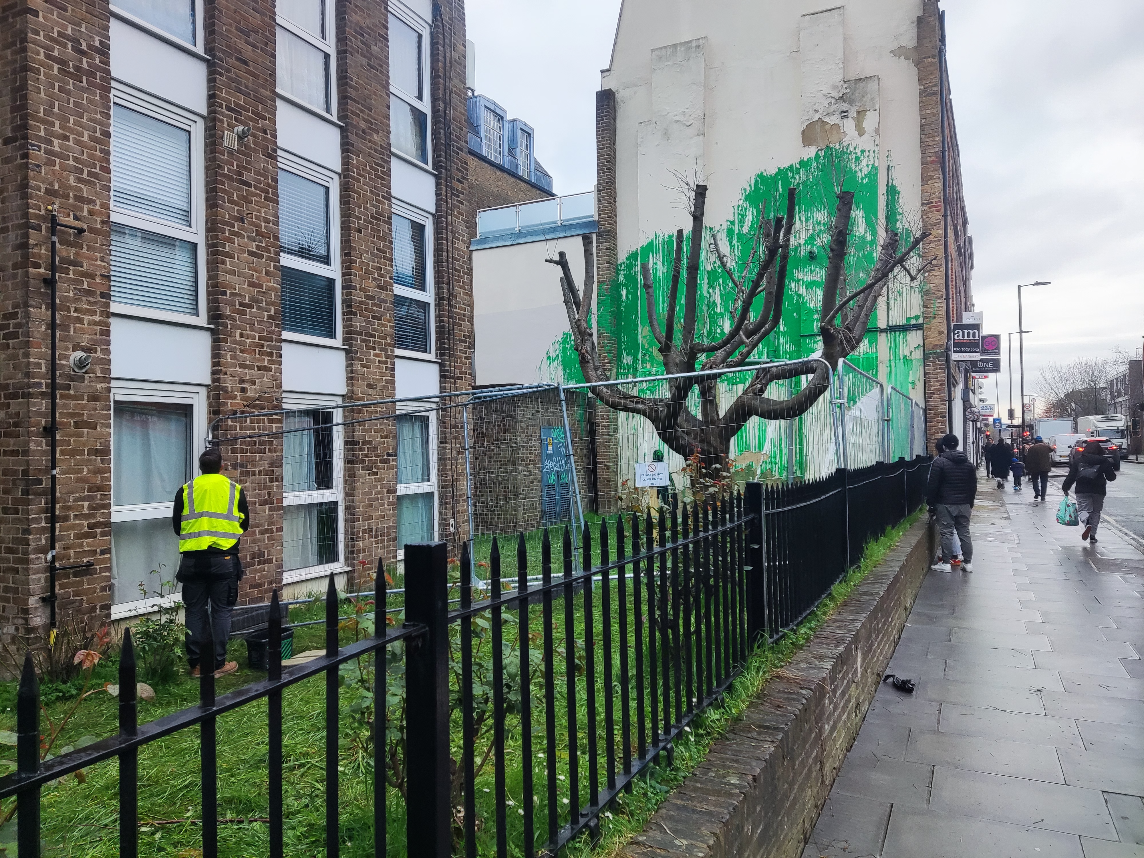 A council worker attempts to remove the tags