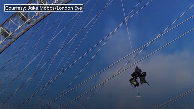 <p>Workers scale 135-metre-tall London Eye and use 5,000 litres of paint to give attraction spring clean.</p>