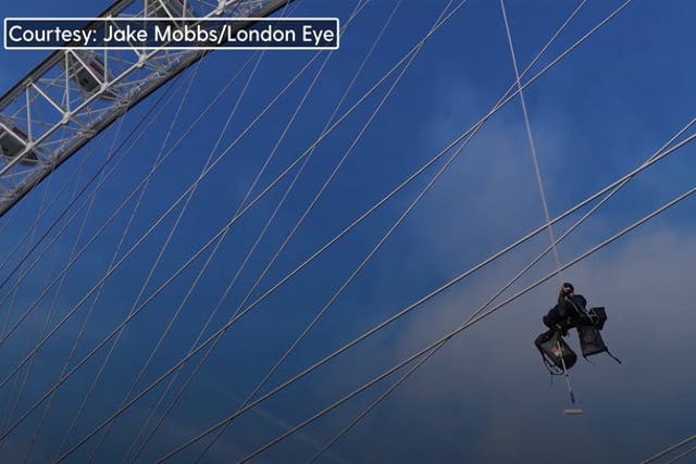 <p>Workers scale 135-metre-tall London Eye and use 5,000 litres of paint to give attraction spring clean.</p>